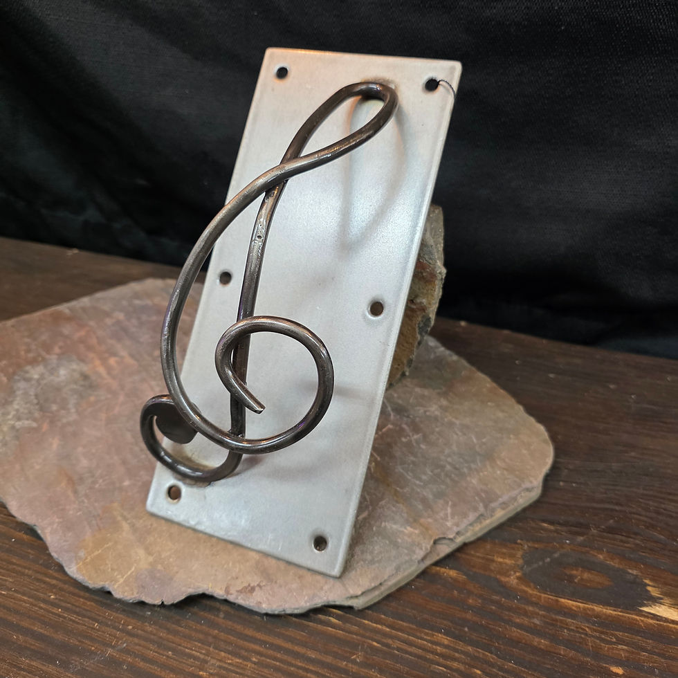 Thumbnail: Handmade stainless steel treble clef door pull mounted on a rectangular metal plate