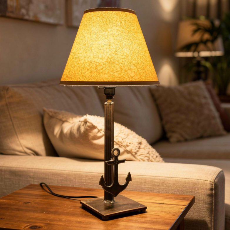 Handmade steel table lamp with anchor detail on square metal base and warm amber textured lampshade
