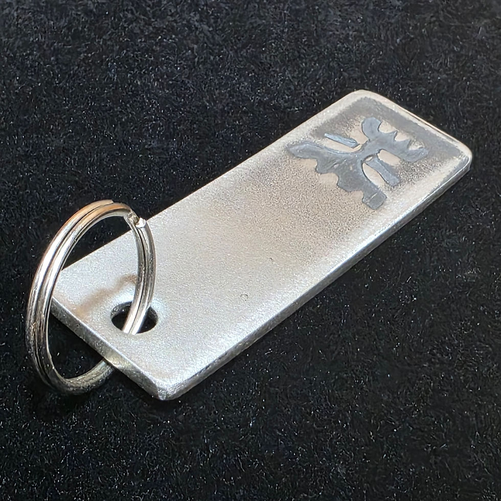 Thumbnail: Group of handmade rectangular steel tiki keychains with brushed metal finish