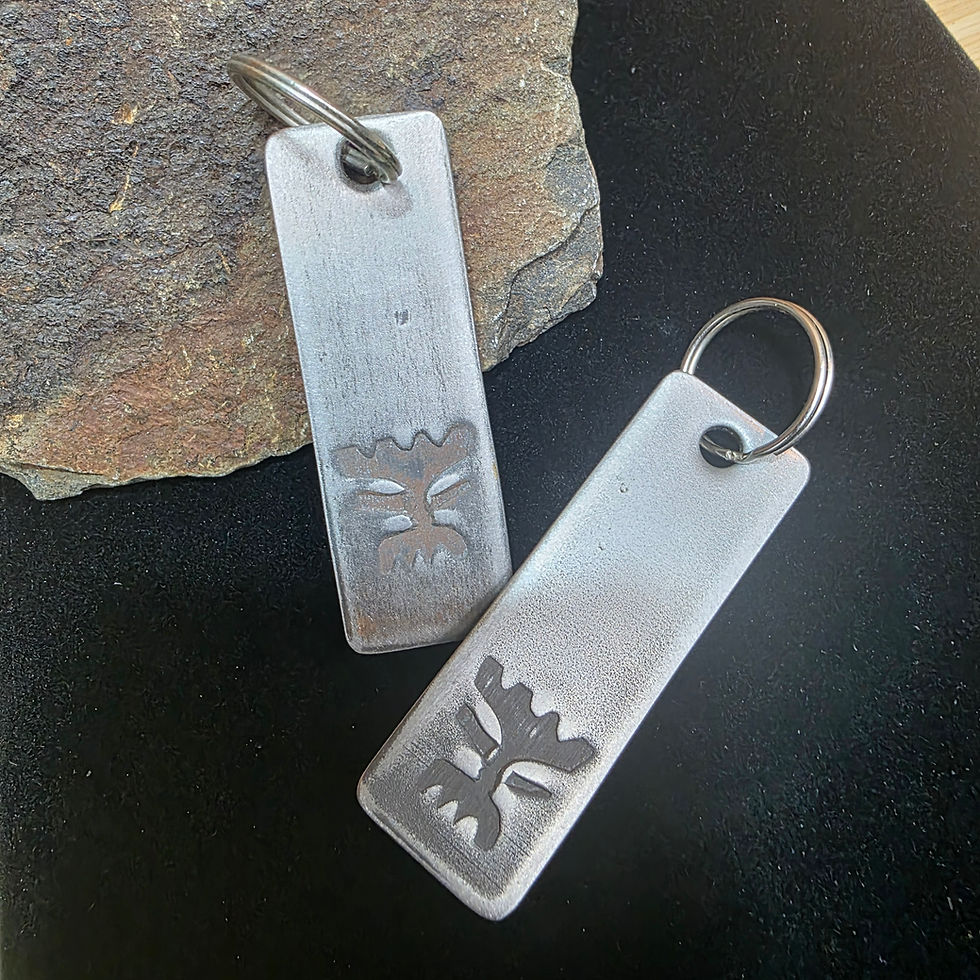 Thumbnail: Minimalist tiki face keychain handcrafted from steel with industrial aesthetic