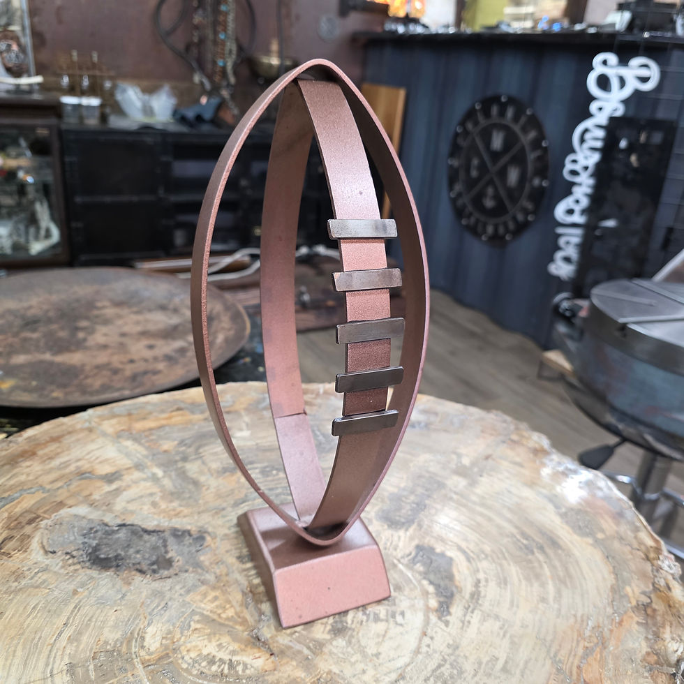 Thumbnail: metal football art piece displayed in workshop setting