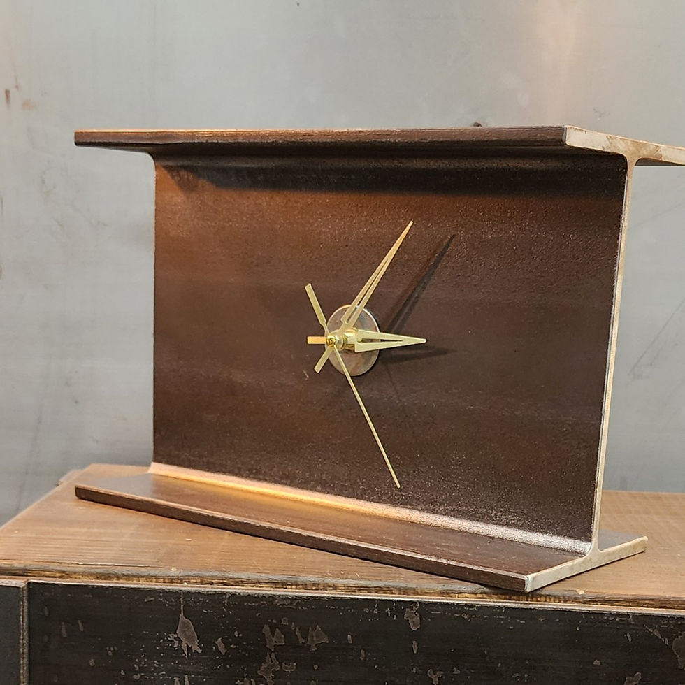 Thumbnail: handmade metal clock from structural steel beam on wood surface