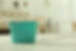 Water dripping from ceiling into plastic bucket on floor in living room, space for text Le