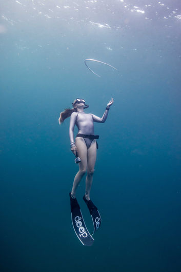 freediver playing with a bubble ring underwater Hawaii
