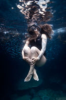 commercial photograph of a diver posing underwater for a wetsuit brand advertisement