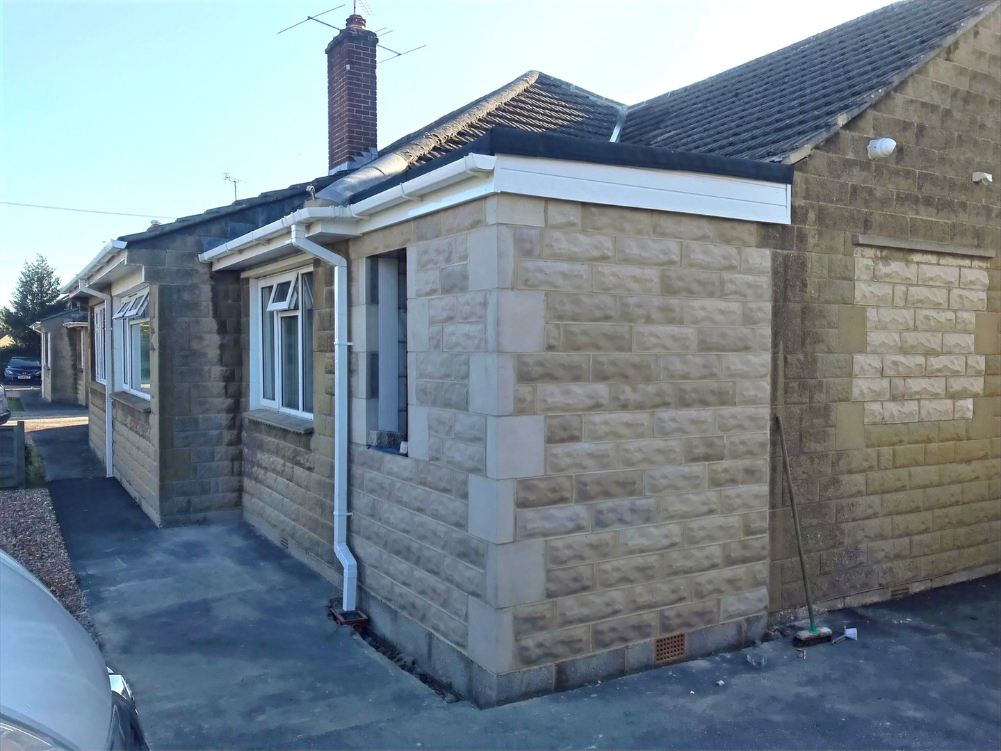 Extension of mid-century bungalow using blockwork, matching stone and installing drainage