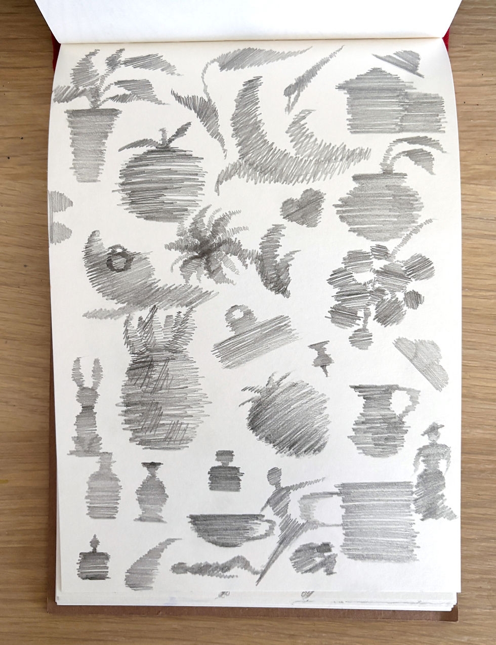 A sketchbook page full of pencil scribbles which look like silhouettes of objects.
