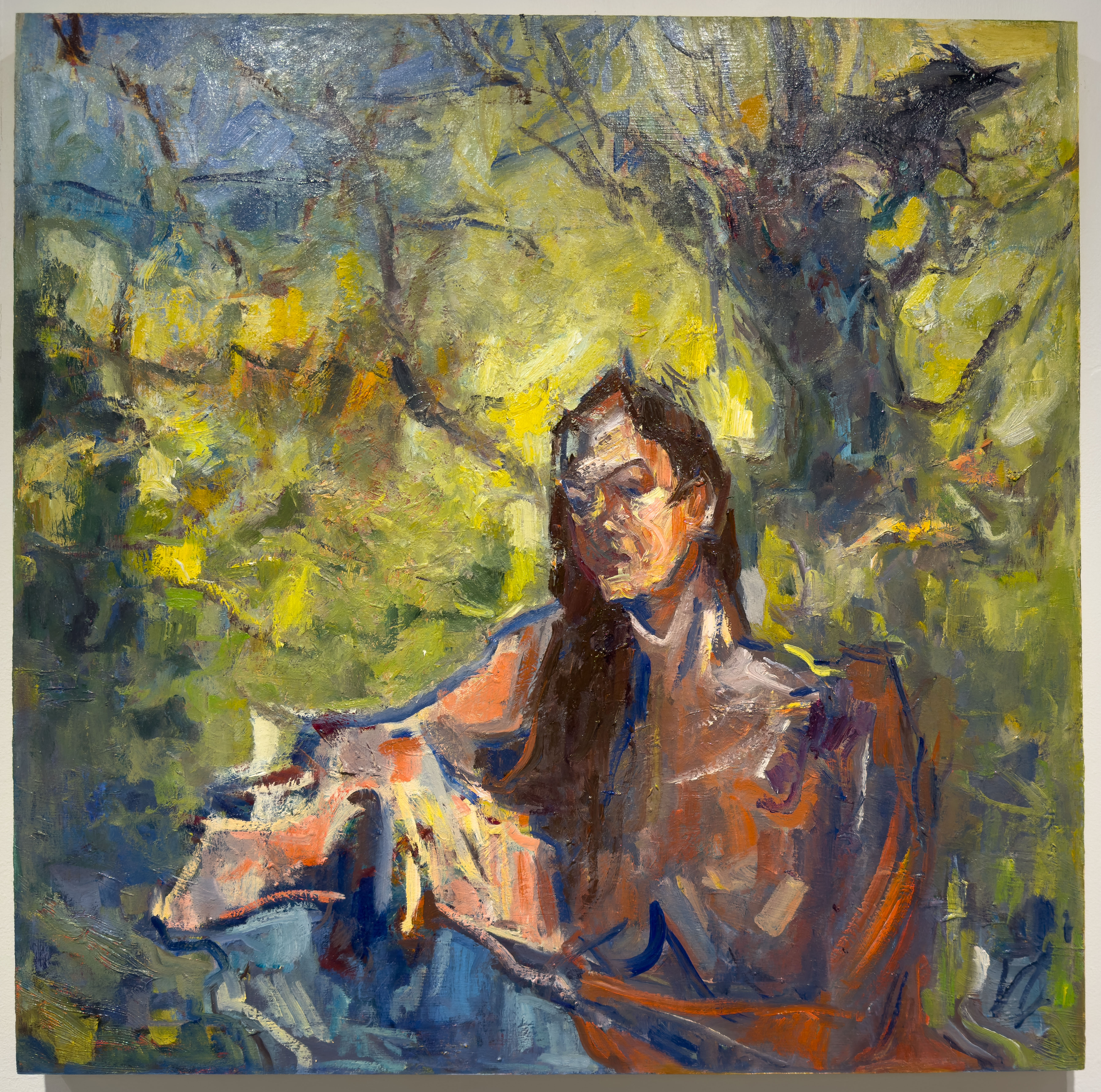 A portrait of a stern woman in a lush forest.