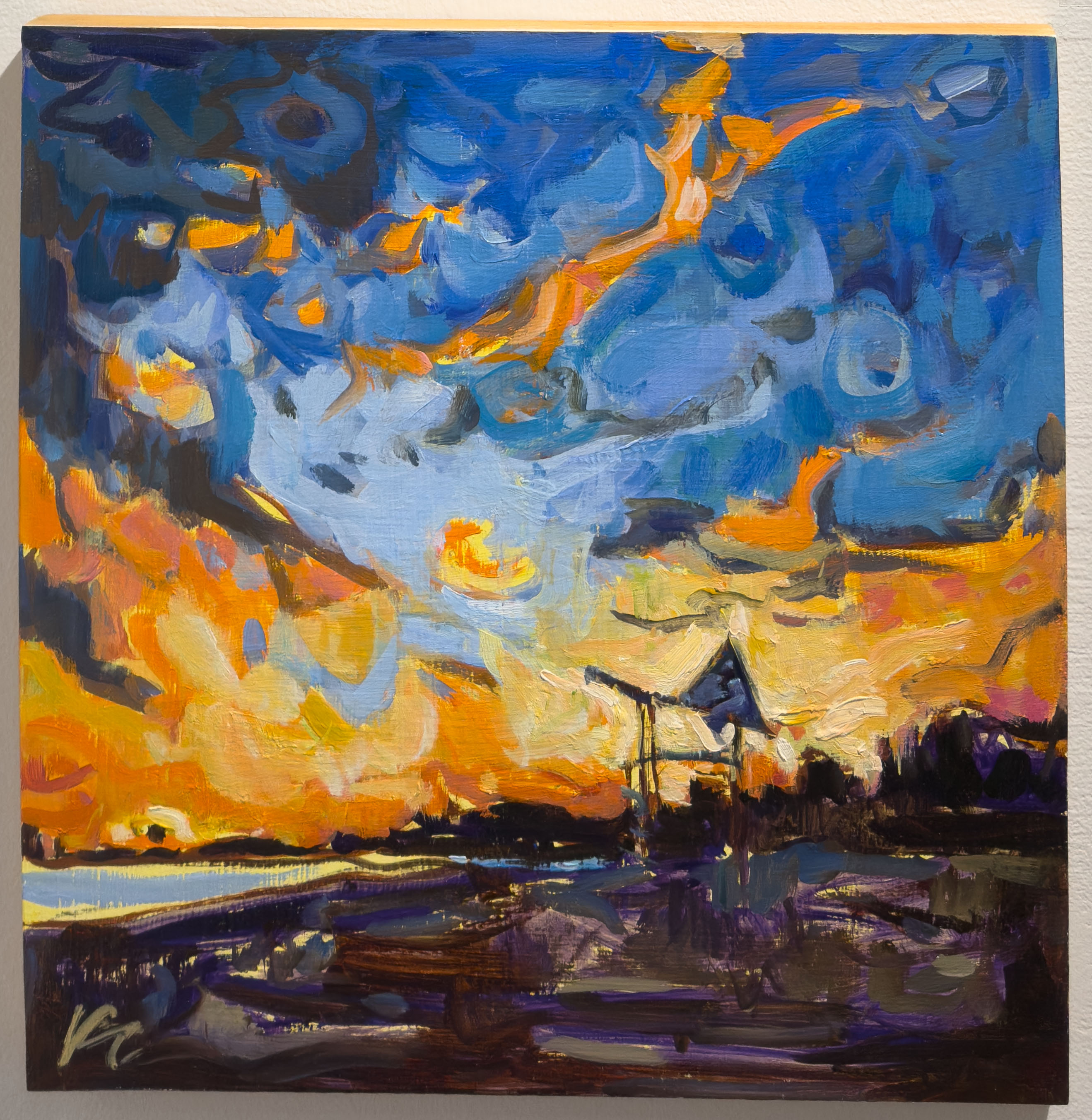 The beach in Port Stanley at sunset with a bright yellow, orange and blue sky.