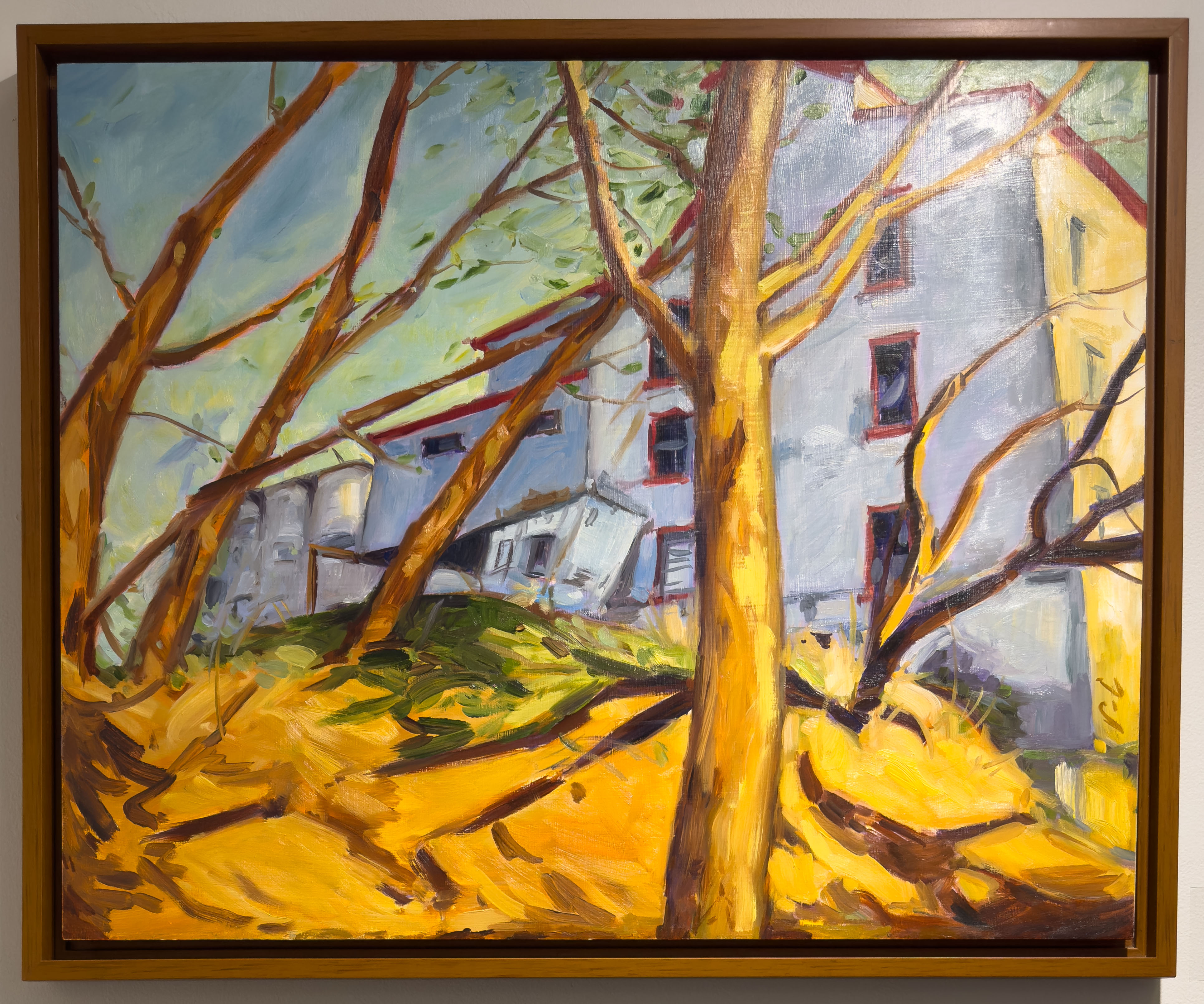 The Thamesford Mill on a bare fall day, the mill looms in the background behind bare trees.