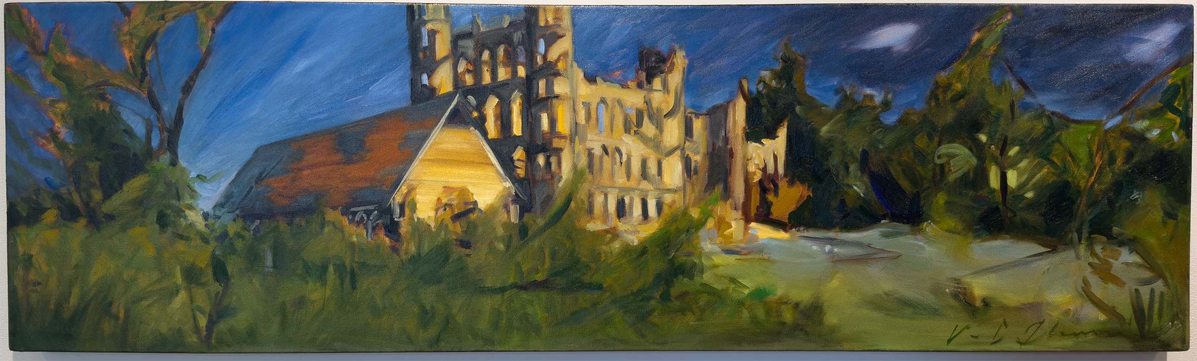 Crumbling buildings in a lush green area with deep blue sky