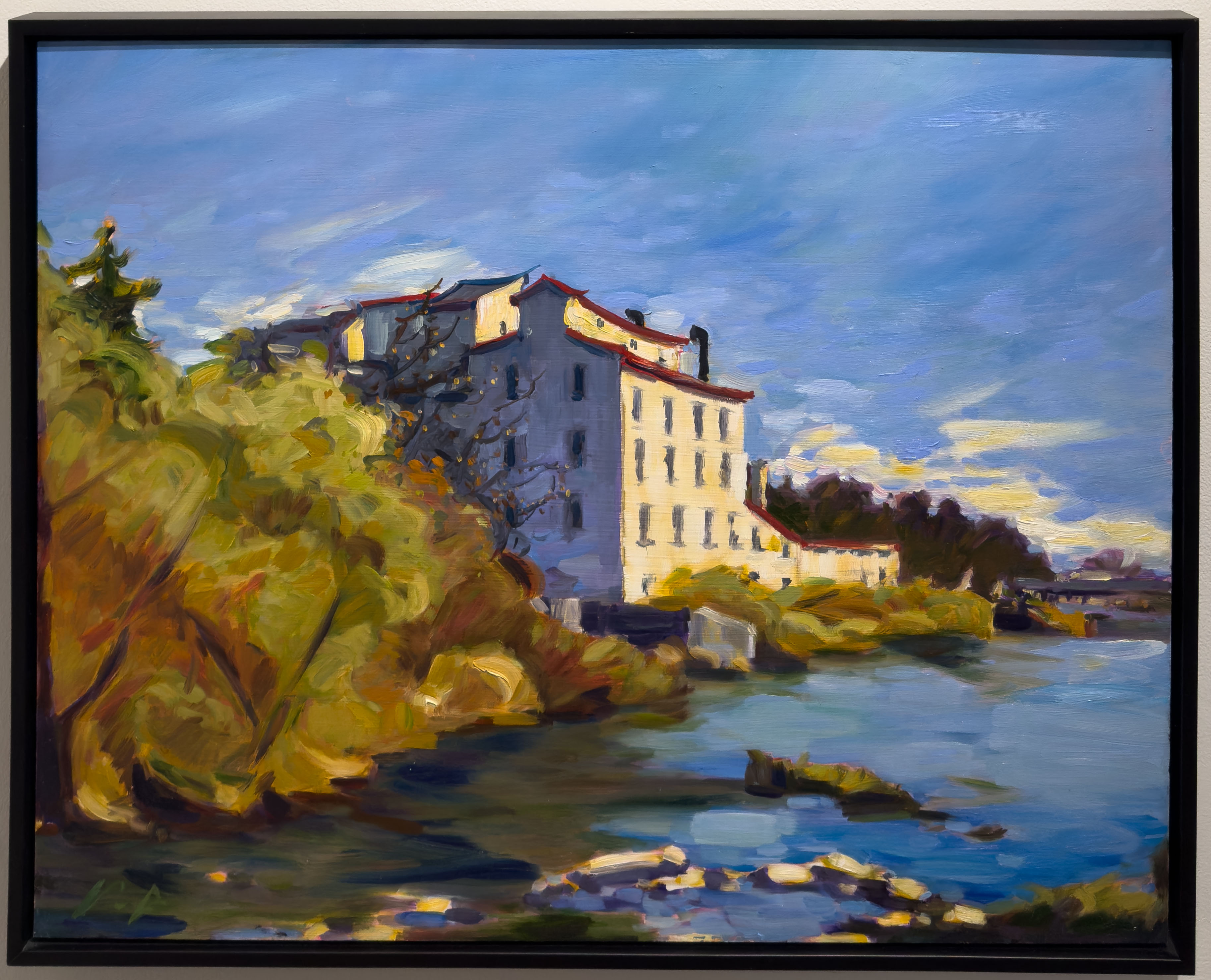 The Thamesford Mill overlooking a river on a bright lush fall day.