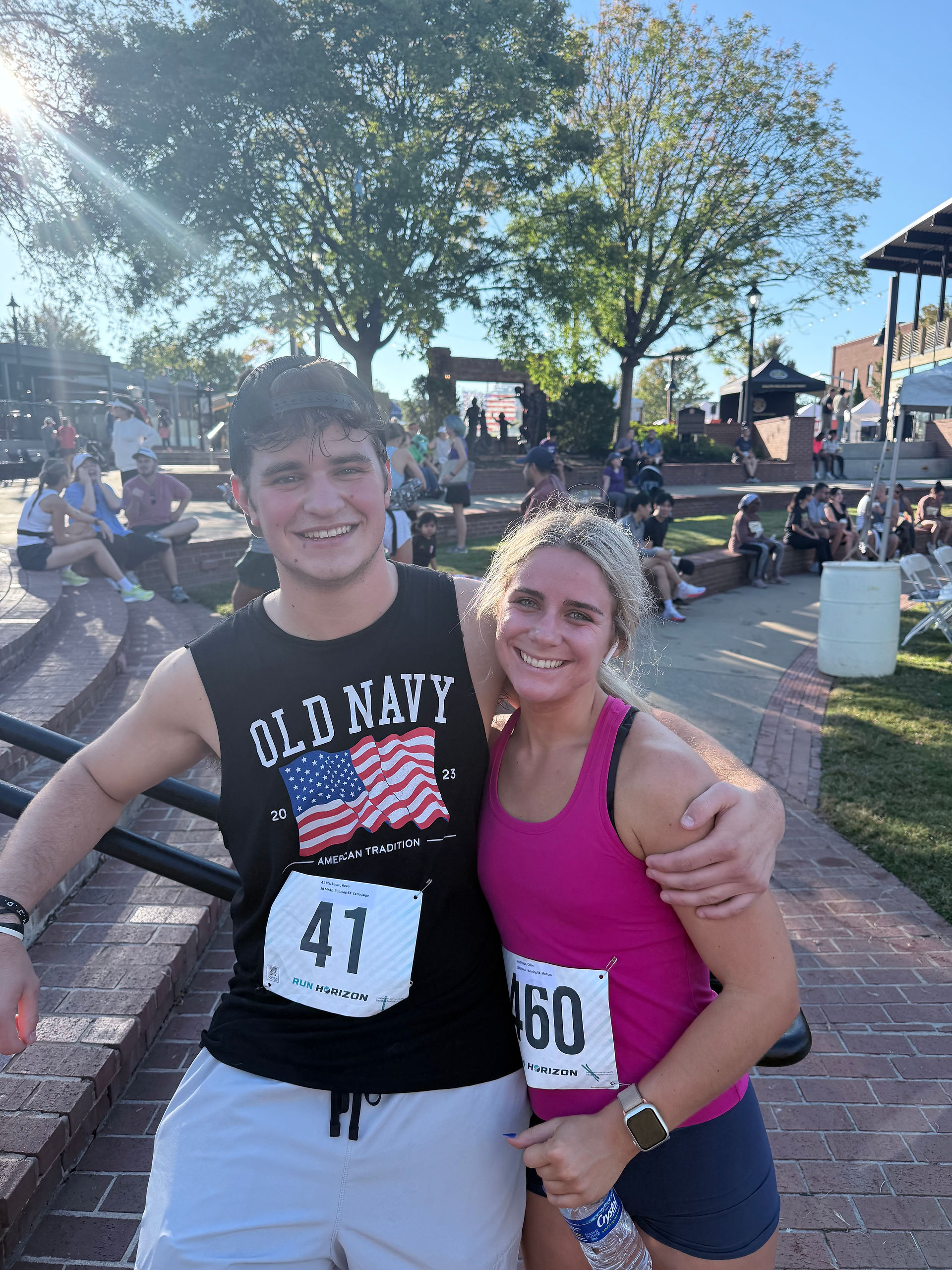 A guy and a girl posing after a race