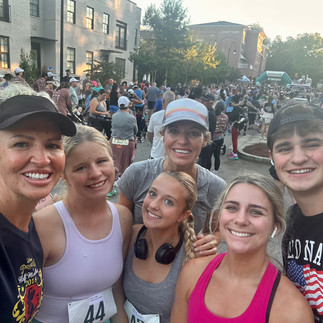 A group of people posing for a selfie after a race