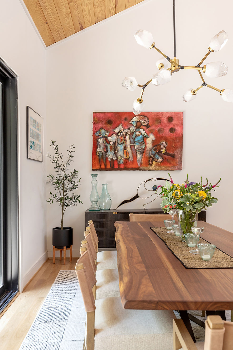 Close-up view of a modern pendant light fixture above a wooden dining table