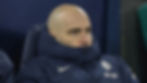 A person in a blue Chelsea jacket sits with a serious expression in a dim setting. Chelsea and BingX logos are visible.