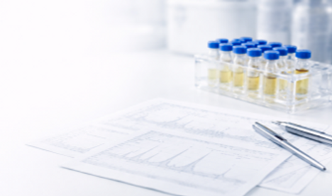 Laboratory equipment with vials, test tubes, and a scientific print for research.