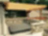 Outdoor hot tub with stone surround and wood pergola