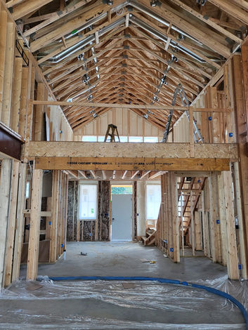New house construction interior showing exposed wood framing and loft.