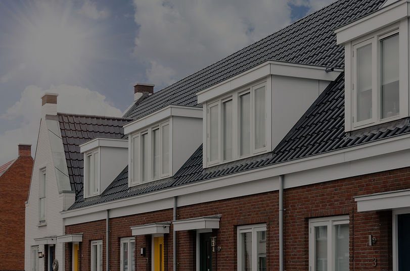 Row of brick houses with white dormer windows