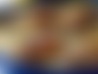 A nourishing one-pan baked chicken and rice dish in a cast-iron pan, featuring golden, crispy chicken thighs over fluffy, herb-infused rice, garnished with fresh parsley.