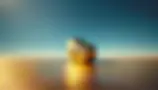 DALL·E 2024-08-24 10.50.06 - A surreal landscape featuring a large solid gold boulder posi