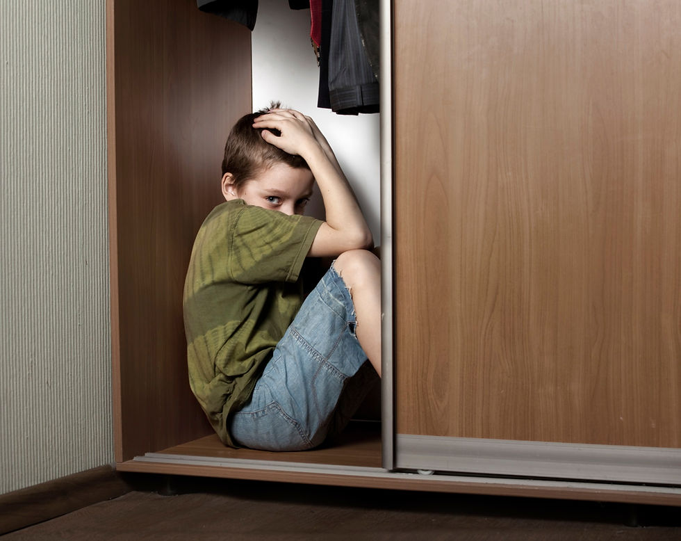 Boy hiding from painful childhood