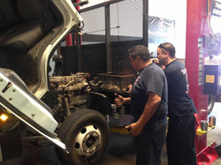 Bossman and Matt work on a truck