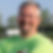 Smiling man in a neon green shirt.png