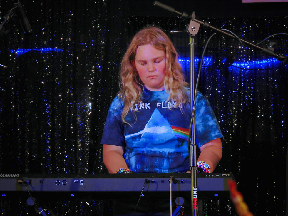 girl in blue shirt playing keyboard