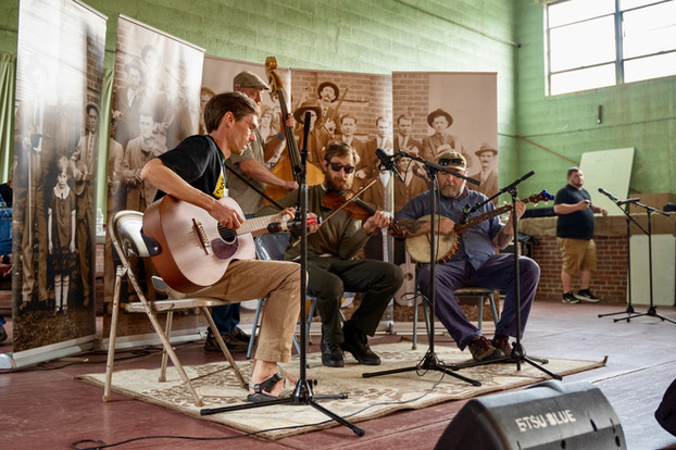 From left, Phil Smith, Tim Pharis and Ryan Bernard perform on stage. All three have played in old-time bands with the ETSU Bluegrass, Old-Time, and Roots Music program.