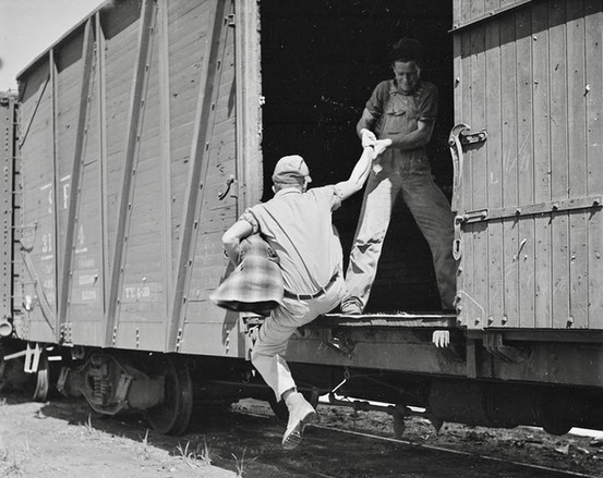 A man is helped onto a railcar