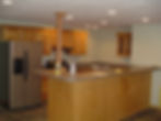 Modern kitchen with wood cabinets and stainless steel fridge