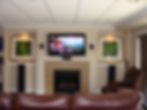 Home theater with TV above fireplace and surround sound