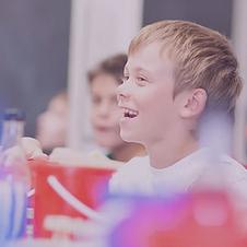 Kid laughing among a group of kids in Sunday School