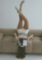 Woman lying upside down on couch reading How To Teach People How To Treat You by Pete Moore.