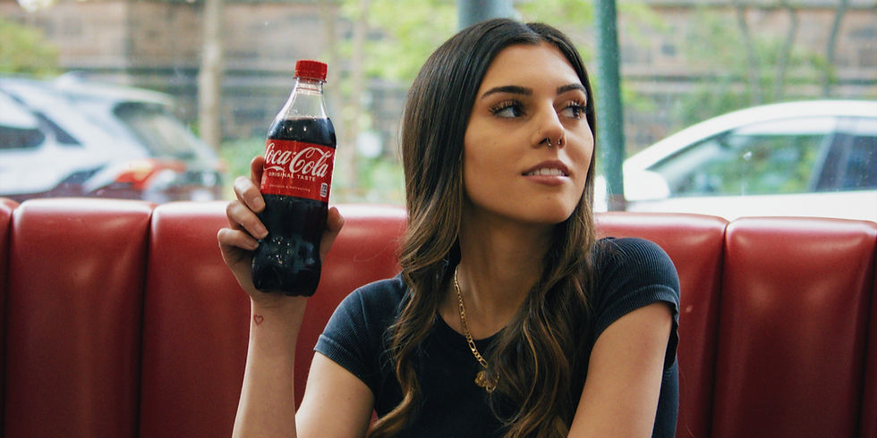 woman modeling a coca cola bottle for photos