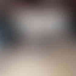 a cat lying on a blanket underneath a desk