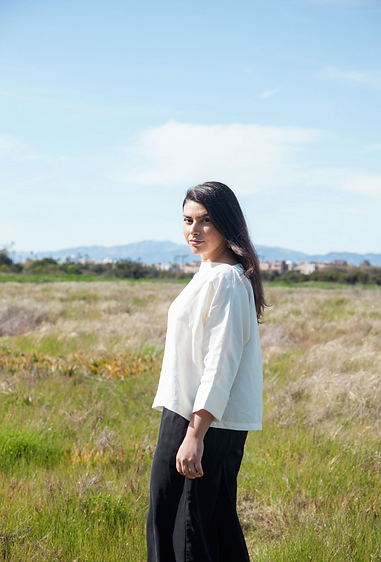 Andrea Penagos in a field of grass at the Ballona Wetlands in Los Angeles, California.