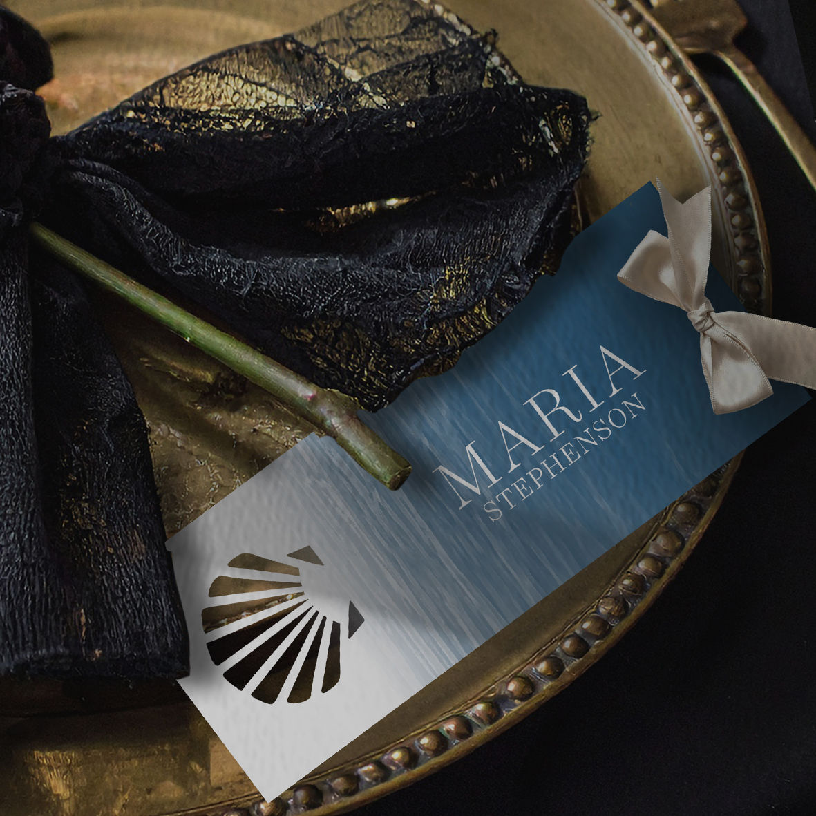 Close-up of laser-cut shell motif on luxury wedding place card