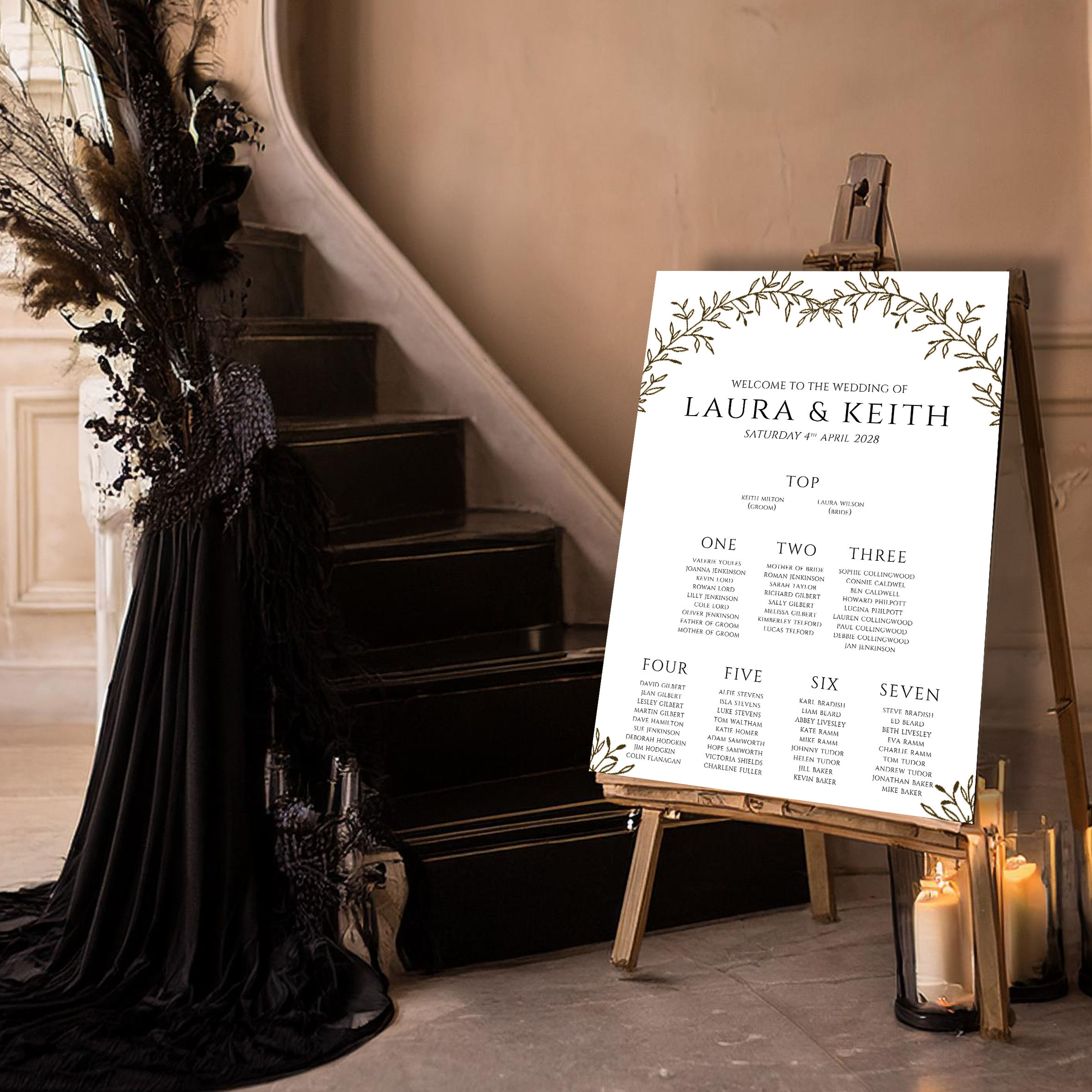 Gold botanical wedding table plan sign with elegant foliage border and classic typography