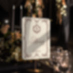 legant wedding table number sign with ornate border and monogram detail on textured card Wedding table number card with decor