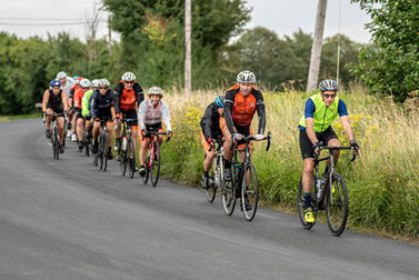Photograph of club members cycling out on the road.