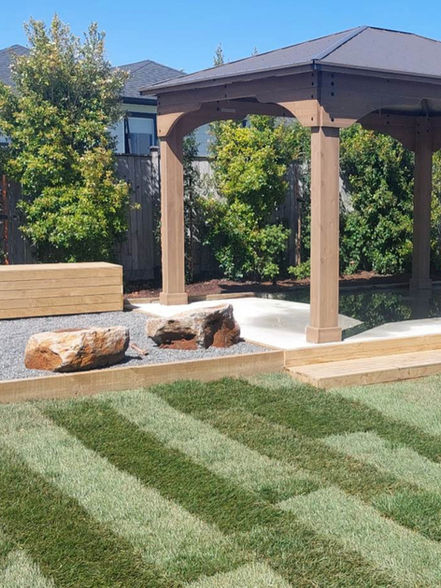 Wooden Pergola over concrete area, stone base fire pit area,