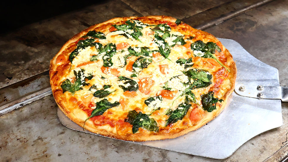 High angle view of a pizza box open with a hot pizza inside on a kitchen counter