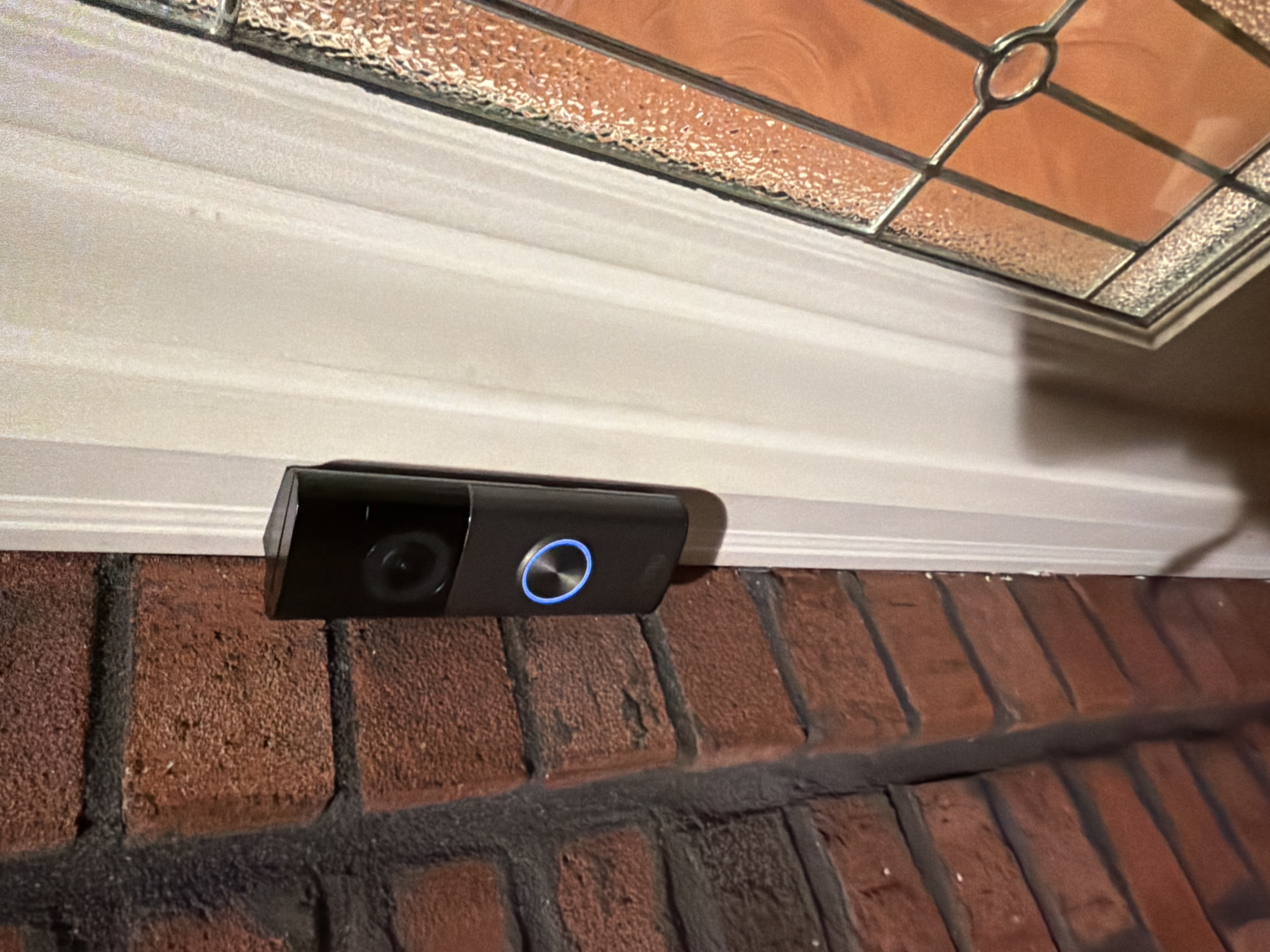 Video doorbell installed beside a residential front door