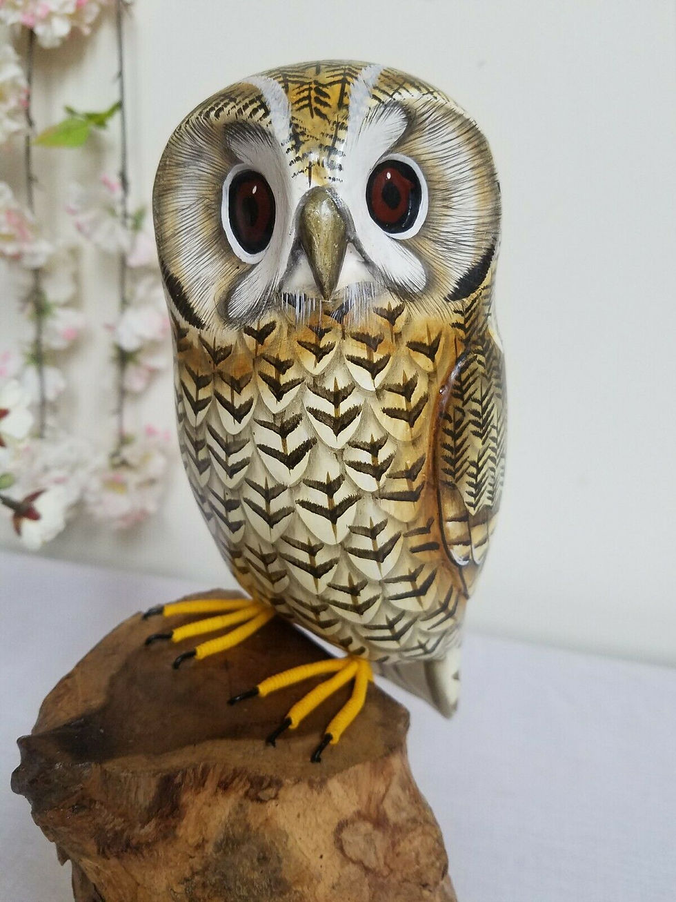 Carved wooden Owl sitting on a tree stump