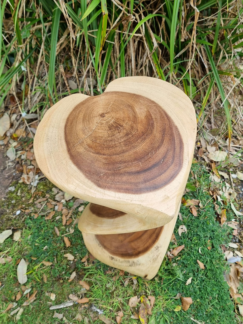 Thumbnail: Heart shaped hand carved twist table in a natural wood finish shown from different angles