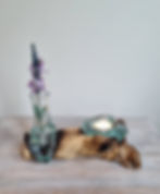 Melted glass on wood small flower vase and tea candle holder, shown with flower stem and tea candle