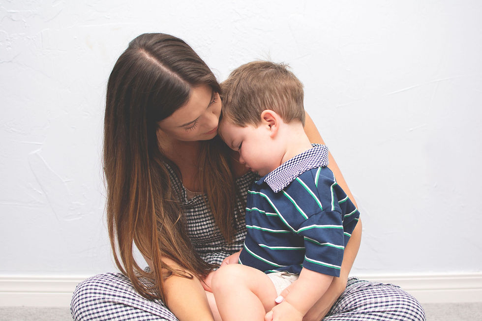A mom consoling her toddler male child